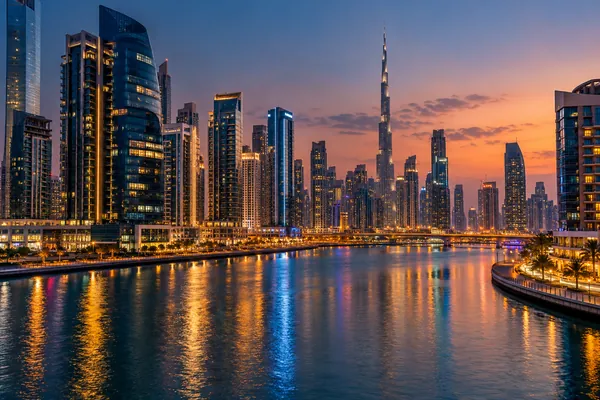 AI-generated illustration of office towers along the Business Bay canal at dusk