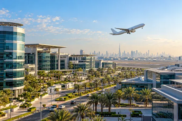 AI-generated illustration of modern office buildings in Dubai Airport Free Zone with an aircraft taking off