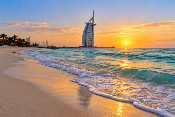 AI-generated illustration of a Jumeirah beach at sunrise with a distant tower