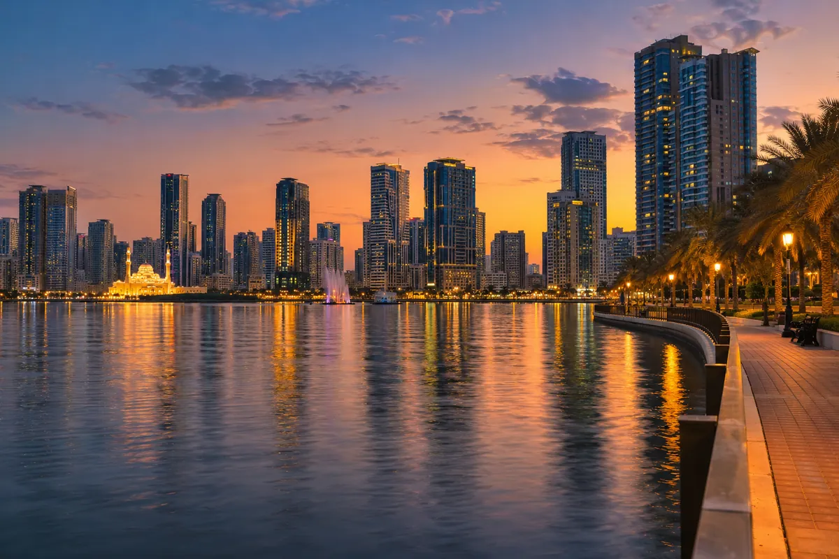 AI-generated illustration of a Sharjah waterfront with towers at dusk